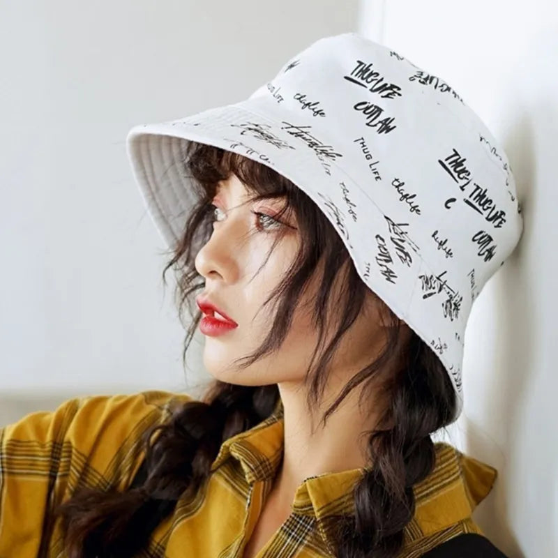 A girl wearing a graffiti style bucket hat
